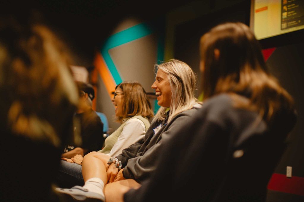 Group of women smiling during an Alpha session where the Christian faith is explored. Alpha is designed to tackle questions around faith and create conversation.