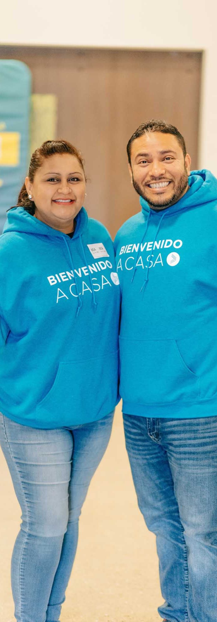 Engedi Español greeters wearing blue shirts that say, "Bienvenido a casa" in Holland, Michigan.