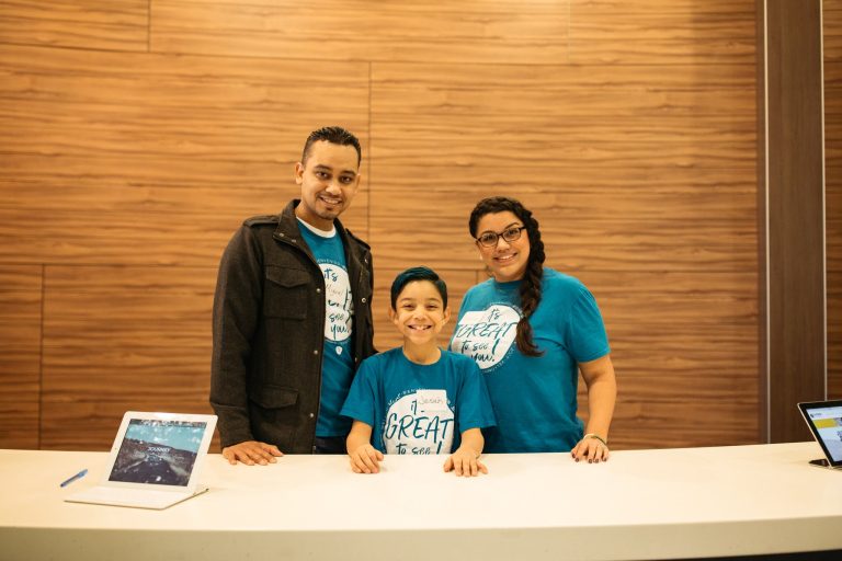 Guest Experience volunteers at the info desk at Engedi Church in West Michigan.