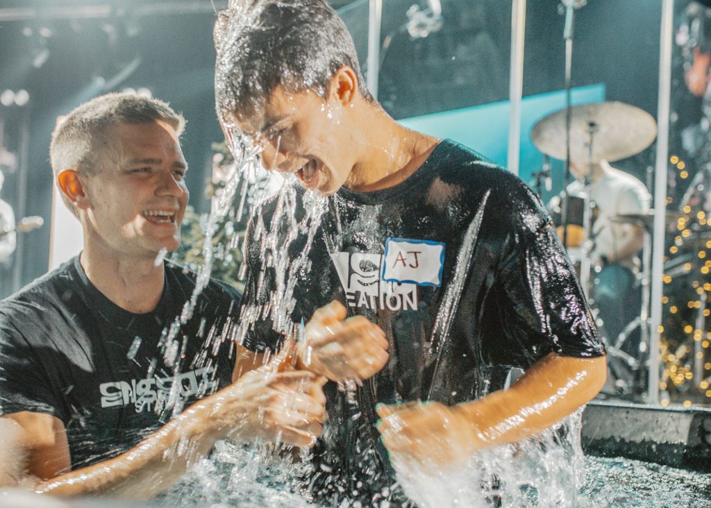 baptism someone baptizing a boy at the gathering