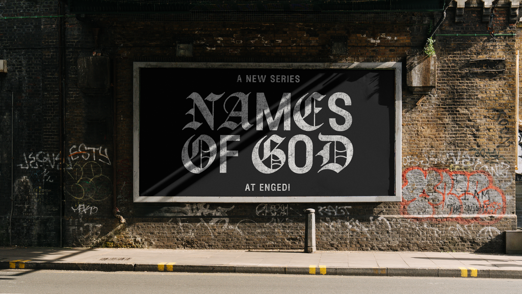 Billboard on a graffiti-splashed brick wall advertising a new series titled 'Names of God' at Engedi.
