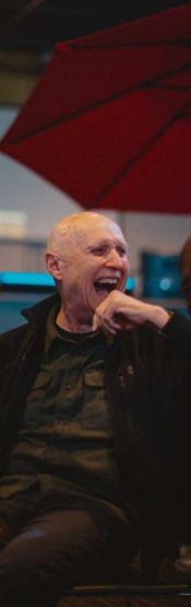 Older gentleman laughing at Volunteer night at Engedi Church.