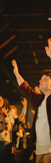 People raise their hands in worship at Engedi Church in West Michigan.